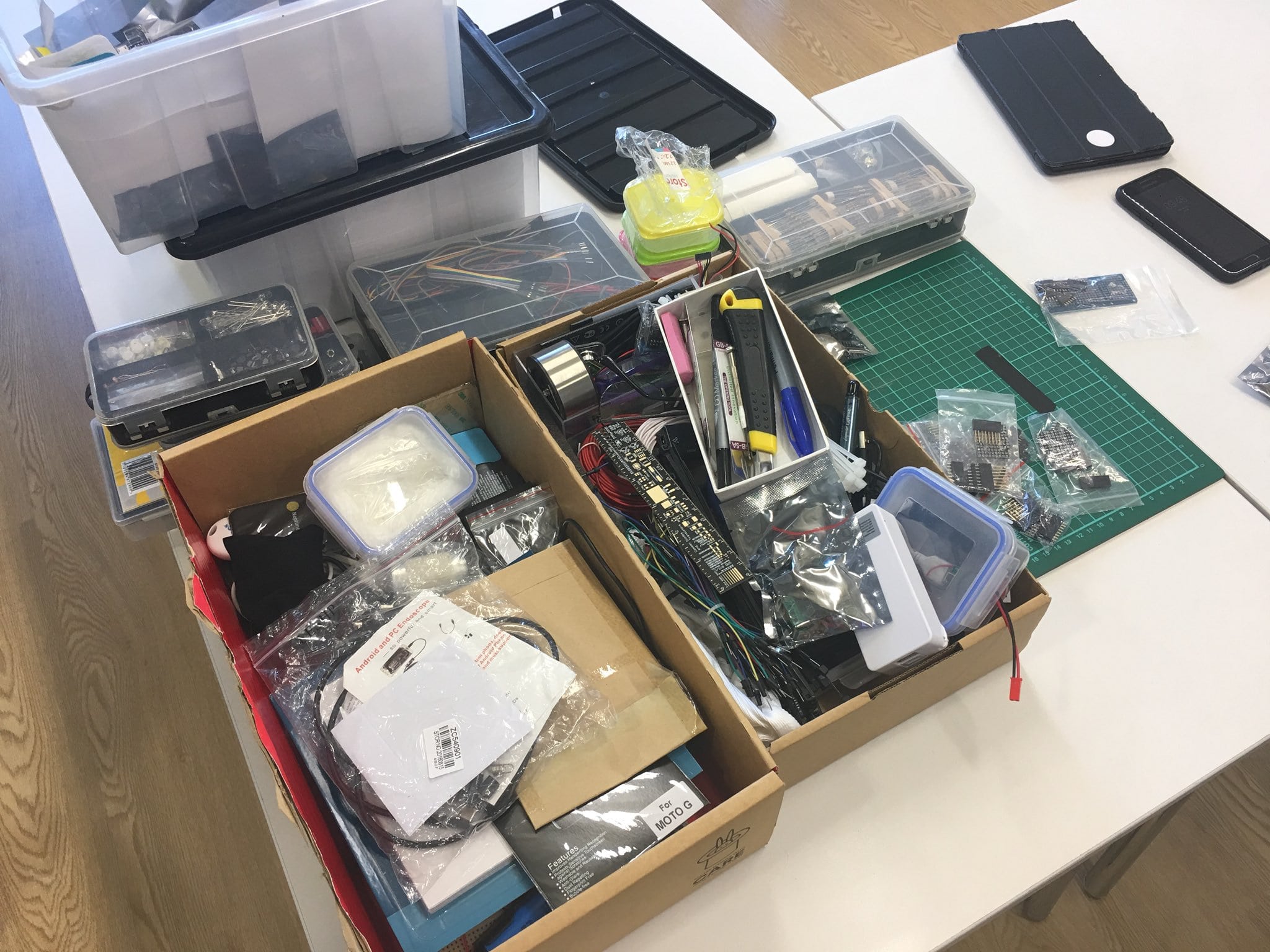 Boxes of electronic components spread across a desk